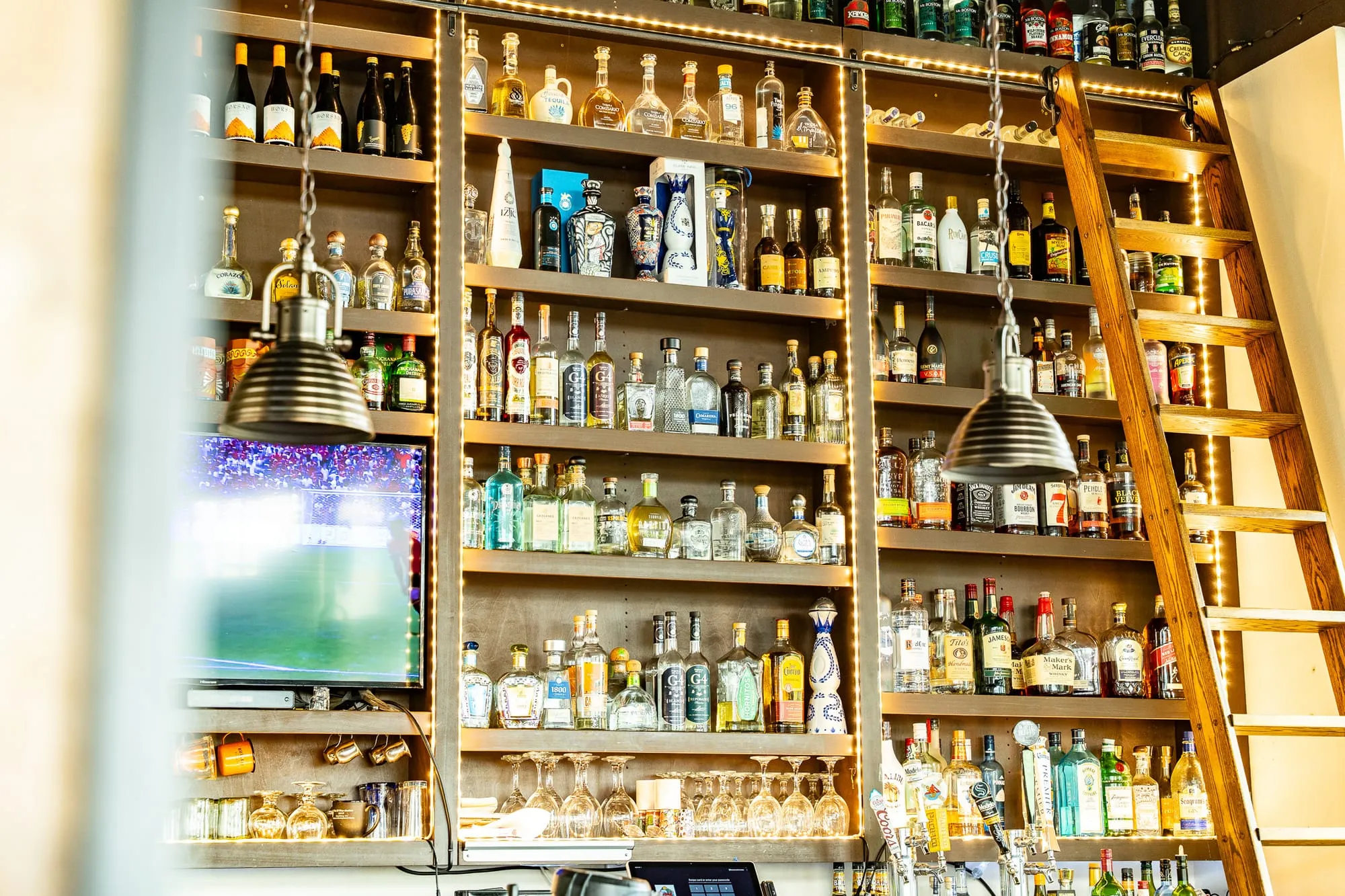 The warmly lit back bar at Cozumel stocked with premium tequilas and spirits