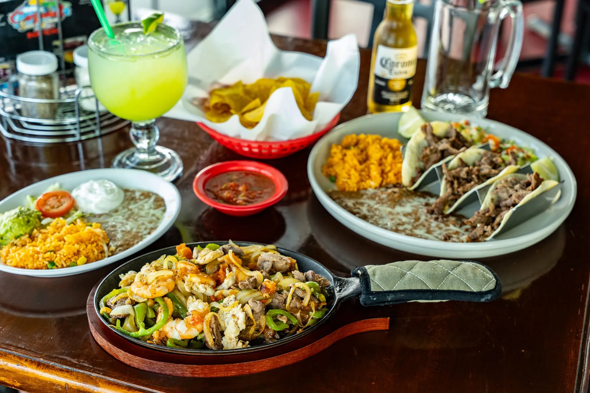 A freshly plated Cozumel entrée beside a classic lime margarita