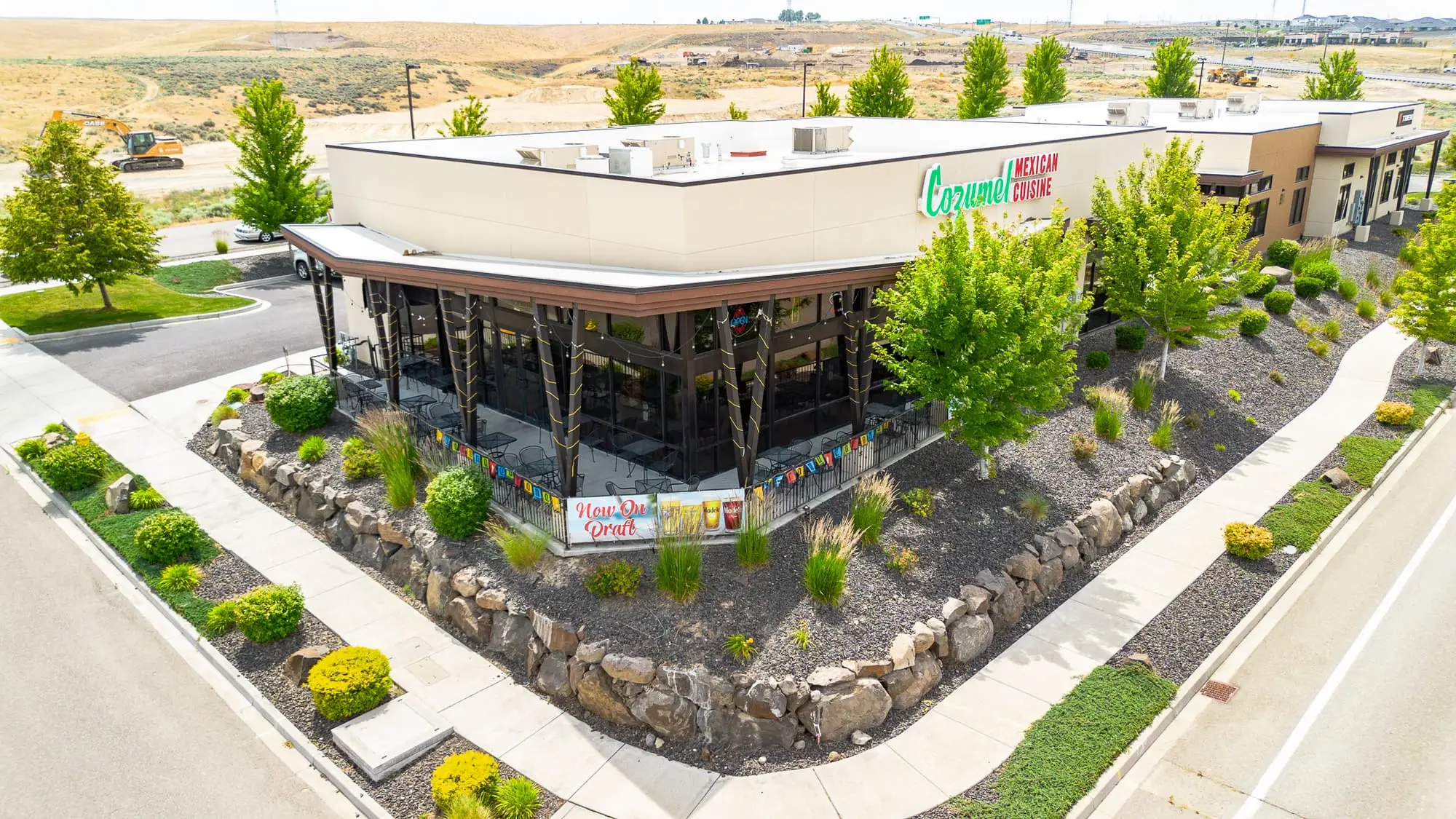 Corner street view of the Cozumel Mexican Cuisine building with its covered patio and desert landscaping